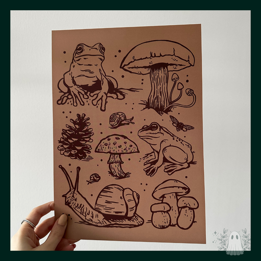 A light brown print with dark brown frogs, mushrooms, pinecones, and snails.