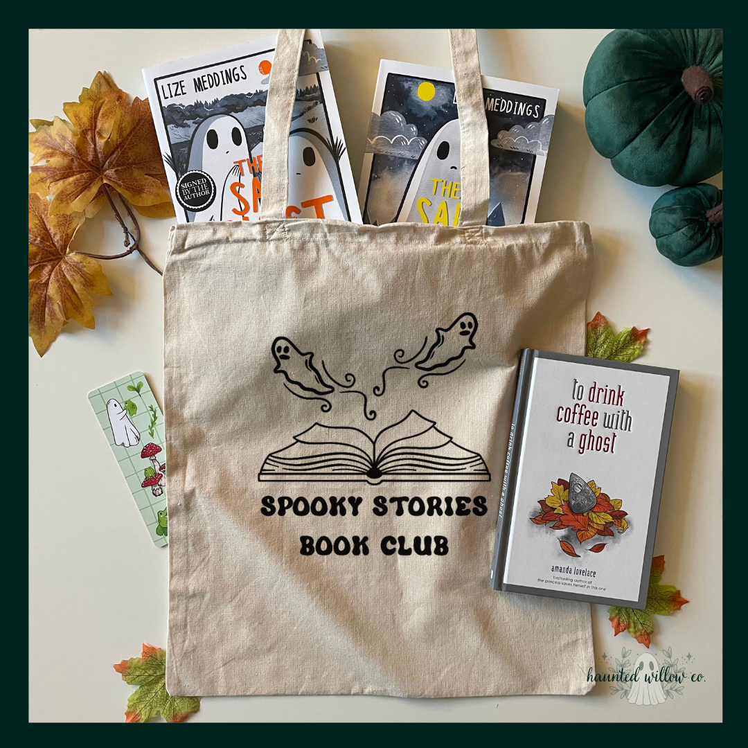 A Flatlay image of a natural canvas cotton tote bag with a 'spooky stories book club' open book with ghosts design. The bag is filled with ghost themed books